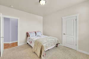 Bedroom featuring carpet floors and baseboards
