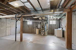 Basement with washing machine and clothes dryer and heating unit