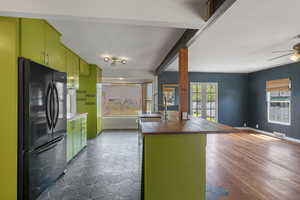 Kitchen with freestanding refrigerator, a sink, butcher block counters, open floor plan, and a ceiling fan