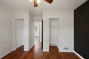 Unfurnished bedroom featuring wood finished floors, baseboards, and a ceiling fan