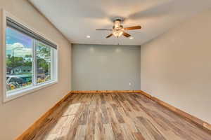 Updated room featuring a ceiling fan, wood baseboards, LVP flooring, and recessed lighting