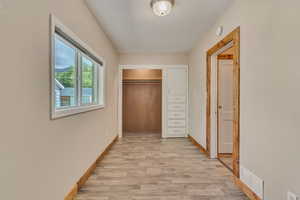2nd bedroom/office with LVP floors and  wood baseboards, closet and built in cabinets