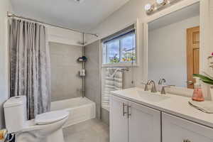 Updated bathroom with quartz countertops and tile surround