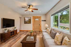 Living area with light LVP floors, a ceiling fan, and recessed lighting