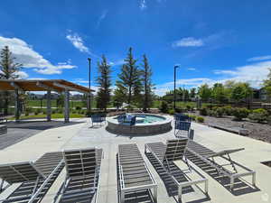 View of swimming pool featuring fence, a patio area, and a community hot tub