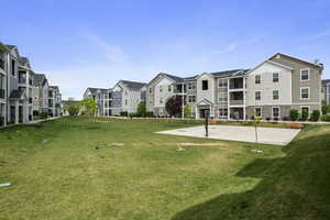 View of property's community with a residential view and a lawn