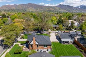 Aerial view of property and surrounding area with a mountain backdrop