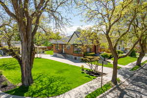 View of front of home with brick siding and a front lawn