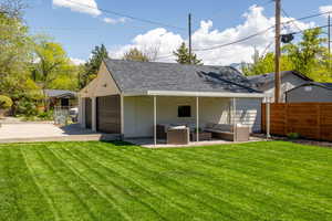 Rear view of house featuring an outdoor hangout area, a shingled roof, and a patio area