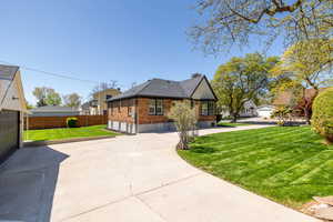 View of side of property with brick siding and roof with shingles