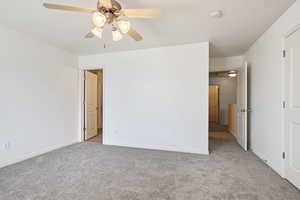 Unfurnished bedroom featuring carpet, baseboards, and ceiling fan