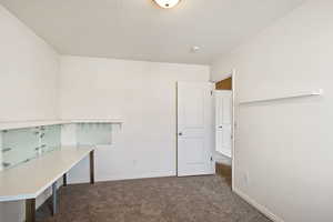 Unfurnished office with carpet and baseboards