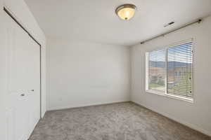 Unfurnished bedroom with a closet, carpet floors, and baseboards
