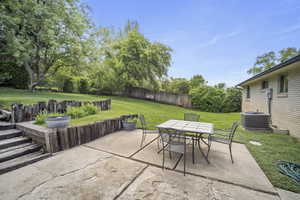 View of patio with central air condition unit and outdoor dining area