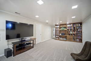 Sitting room with ornamental molding, carpet, baseboards, and recessed lighting