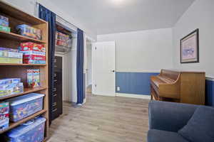 Sitting room featuring wood finished floors and a wainscoted wall