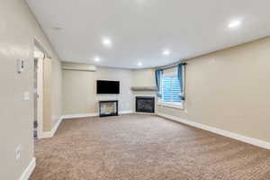 Basement recreation room features gas fireplace