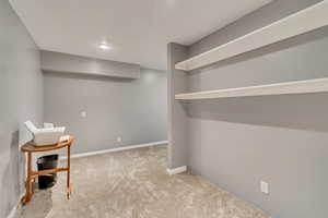 Finished below grade area featuring carpet and baseboards