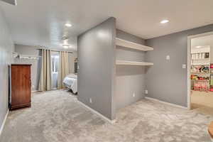 Unfurnished bedroom with carpet flooring, recessed lighting, baseboards, and a walk in closet