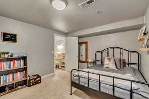 Bedroom featuring a textured ceiling, carpet flooring, and baseboards