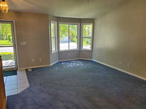 living room with bay windows next to front door
