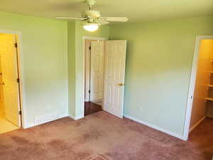 Unfurnished bedroom featuring carpet, baseboards, and ceiling fan