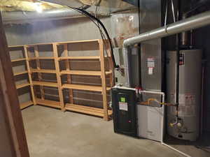 Utility room featuring gas water heater and heating unit