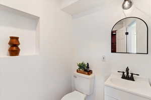 Bathroom with toilet, vanity and shower stall