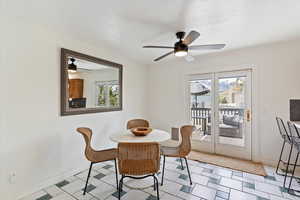 Dining room featuring plenty of natural light, ceiling fan, and baseboards
