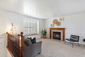 Carpeted living room with a fireplace