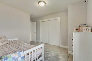 Carpeted bedroom featuring baseboards, a closet, and visible vents