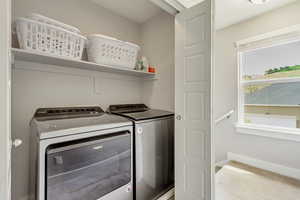 Laundry room featuring baseboards, laundry area, and washer and clothes dryer
