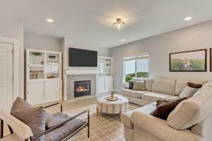Living room with a fireplace and recessed lighting