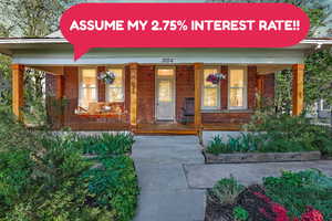 Doorway to property featuring covered porch and brick siding