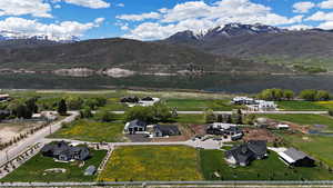 Aerial view of property and surrounding area with a water and mountain view