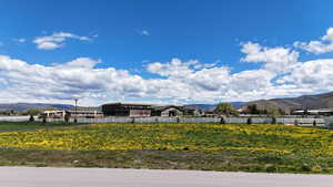 View of yard with a mountain view and fence