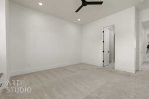 Carpeted spare room featuring a ceiling fan, recessed lighting, baseboards, and a smoke detector