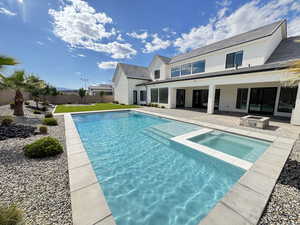 View of pool featuring a patio area and a pool with connected hot tub