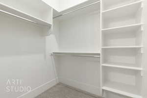 Spacious closet with carpet floors