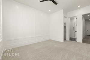 Unfurnished bedroom with a decorative wall, carpet, recessed lighting, and ceiling fan