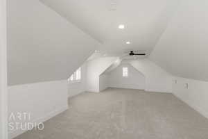 Additional living space featuring recessed lighting, light colored carpet, baseboards, vaulted ceiling, and ceiling fan