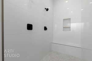 Bathroom featuring a tile shower and tile patterned flooring