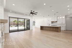 Unfurnished living room featuring ceiling fan, recessed lighting, baseboards, light wood-type flooring, and a sink