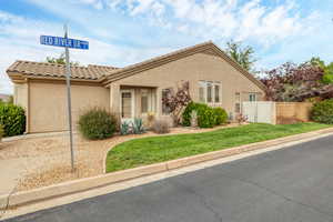 View of front of home featuring a tile roof and stucco siding