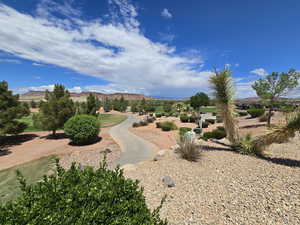 View of home's community with a mountain view and trails near golf course