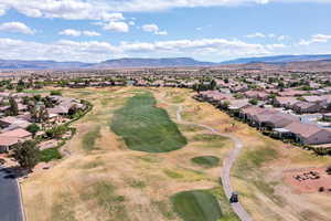 mountain backdrop, and a golf course