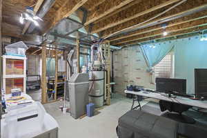 Unfinished below grade area with secured water heater and an office area