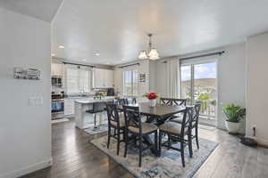 Dining space with hardwood / wood-style floors, baseboards, recessed lighting, and a textured ceiling