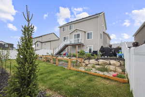 Back of property with stairs and stucco siding