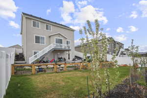 Back of house with stucco siding and stairs